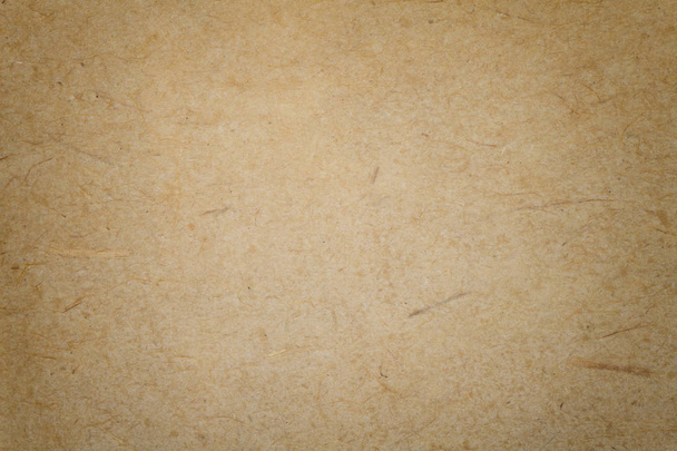 Textura de fondo de papel marrón oscuro vintage con viñeta. Estructura de cartón kraft beige denso con marco. Fondo de gradiente de fieltro primer plano
. - Foto, imagen