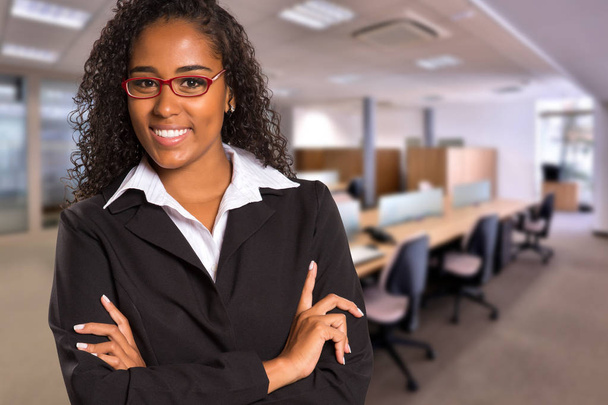Brazilian black business woman looking at camera on blurred office background. Copy space - Valokuva, kuva