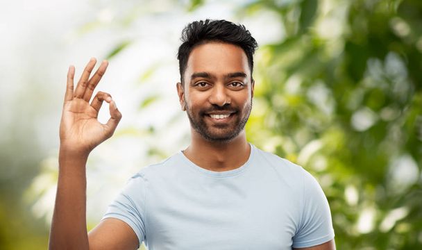happy indian man in t-shirt showing ok hand sign - Foto, afbeelding