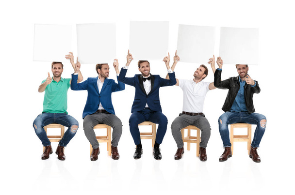 team of same man holding and presenting blank boards on white background, collage image - Foto, immagini
