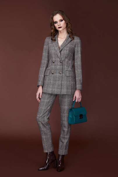 Beautiful sexy woman wear for meeting date business style suit jacket pants hand bag accessory fashion collection shoes model pose long brunette hair natural make up businesswoman casual clothes. - 写真・画像
