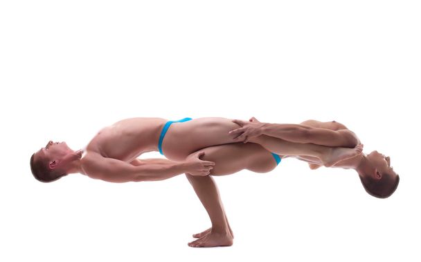 Profile of two young acrobats balancing - Фото, зображення