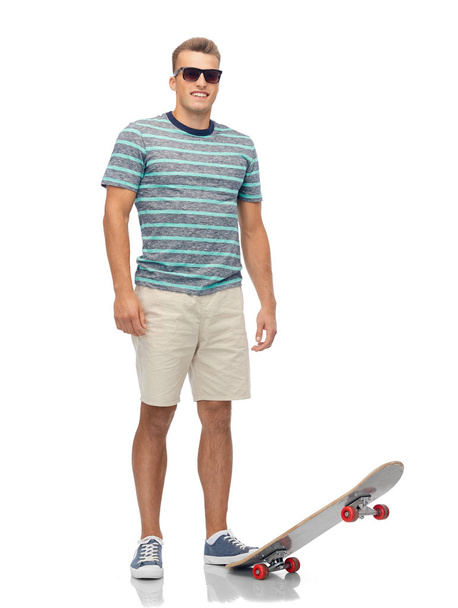 smiling young man with skateboard over white - Foto, Imagem
