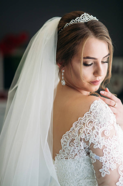 Portrait of a bride in a wedding dress. The bride dresses in the hotel - Photo, Image