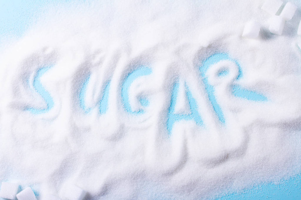 Sugar on blue background - Φωτογραφία, εικόνα