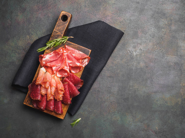 Raw smoked meat slicing on the wooden board. - Photo, Image