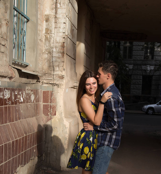 happy, loving couple, family. hugging and laughing. summer girl in a dress. a date in the city. - Foto, Bild