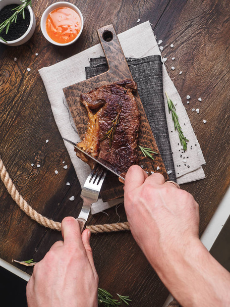 Ribeye stake with spices on the wooden board. - Foto, Imagem