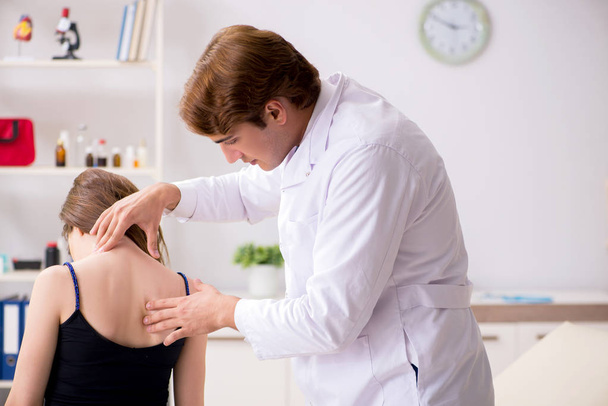 Female patient visiting young handsome doctor chiropractor  - Photo, Image
