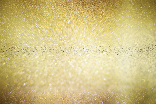 gold glittering christmas lights. Blurred abstract background - Foto, afbeelding