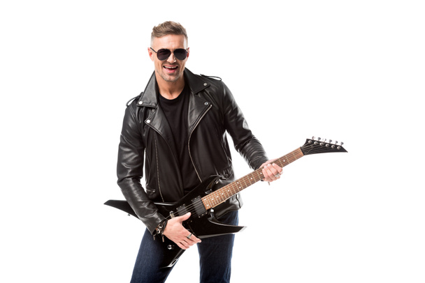 handsome adult man in leather jacket holding electric guitar isolated on white - Photo, Image