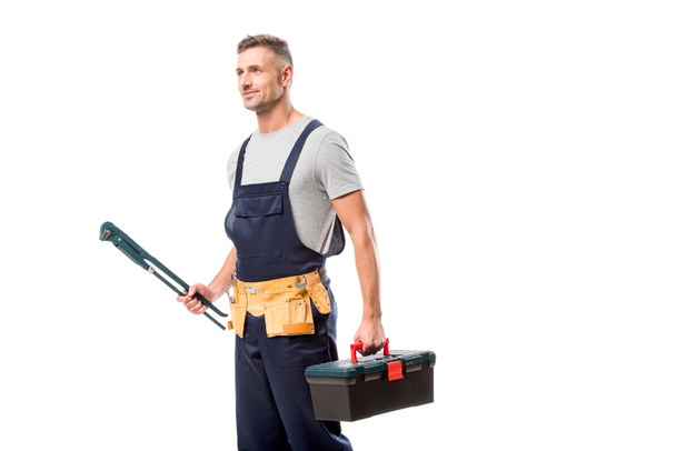 handsome worker holding pipe wrench and tool box isolated on white - Photo, Image