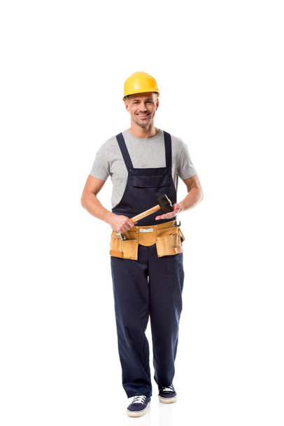 construction worker with tool belt holding hammer isolated on white - Foto, immagini
