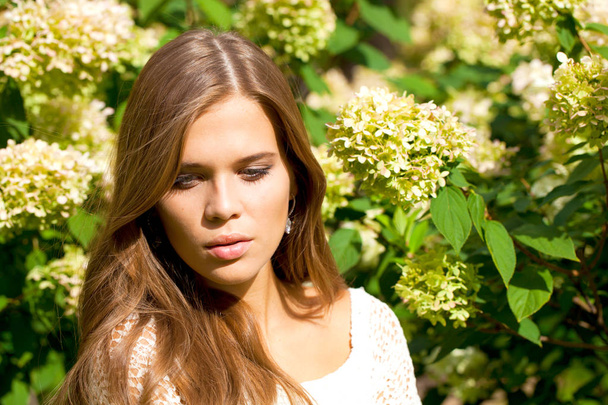 Portrait close up of young beautiful woman, on green background summer nature - Zdjęcie, obraz