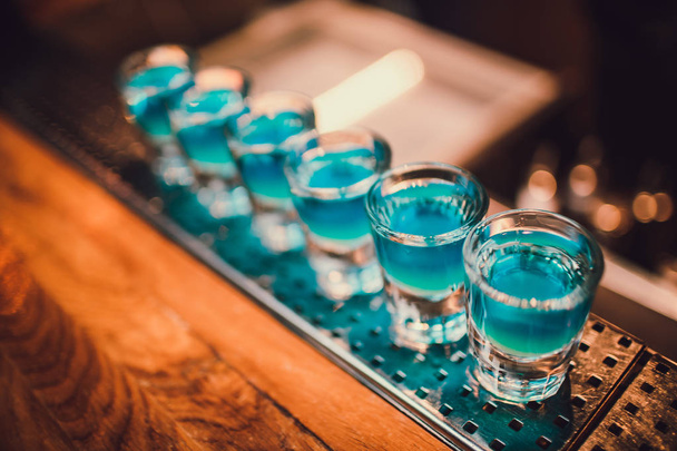 Cocktails at the club. Blue cocktails in the club. Set of cocktails on the bar. - 写真・画像