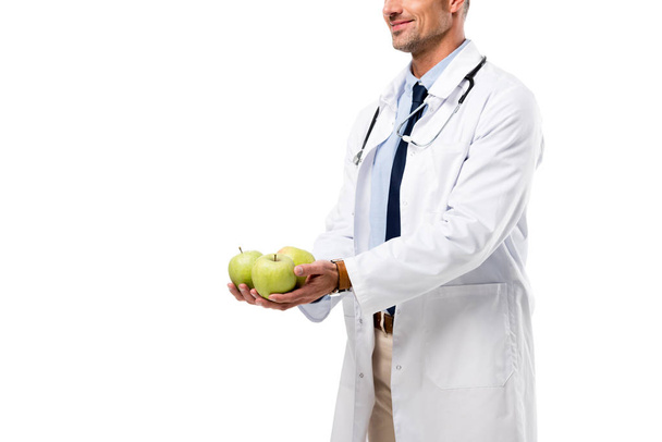 cropped view of doctor holding fresh apples in hands isolated on white, healthy eating concept - Photo, Image