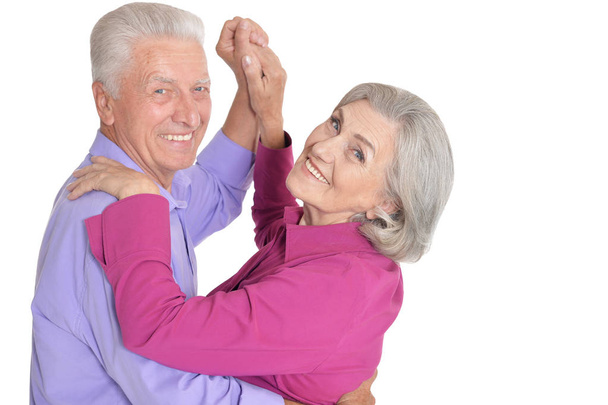 Portrait of happy senior couple dancing isolated on white background - Фото, зображення