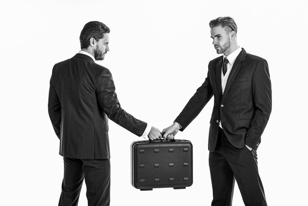 Business exchange concept. Handover of suitcase in hands of part - Fotó, kép