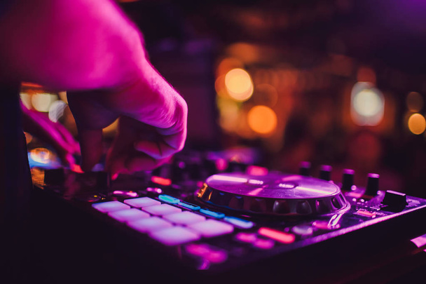 DJ remote, turntables, and hands . Night life at the club, party. - Photo, Image