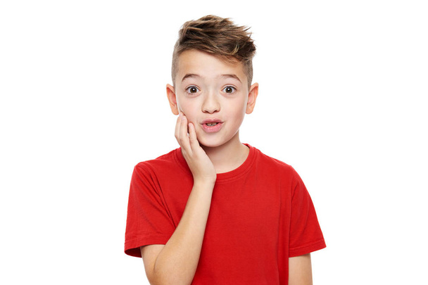 Adorable young boy in shock, isolated over white background. Shocked child looking at camera in disbelief. Shock, amazement, surprise concept. - Photo, image