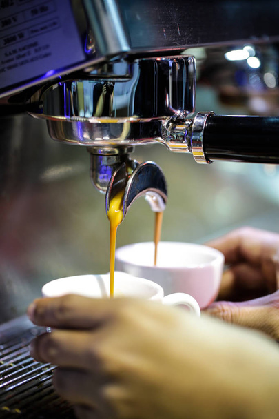 Espresso geschoten vanaf koffiemachine in de coffeeshop, koffie-/ theevoorzieningen in coffeeshop - Foto, afbeelding
