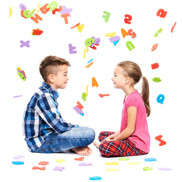 Cute children with large colorful alphabet letters on white background. Kids speech therapy concept. Speech impediment, logopedy background. - 写真・画像
