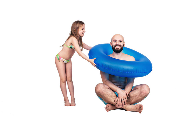 glücklicher bärtiger Vater und kleines Mädchen mit aufblasbarem Kreis isoliert auf weißem Hintergrund - Foto, Bild