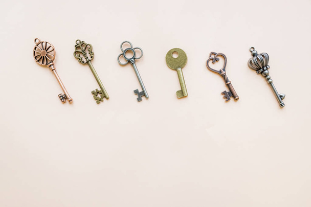 Collection vintage keys isolated. Flat lay. Top view.Antique keys flat lay pattern isolated on pastel background.old keys , small retro key collection, key pattern.Copy space - Photo, Image