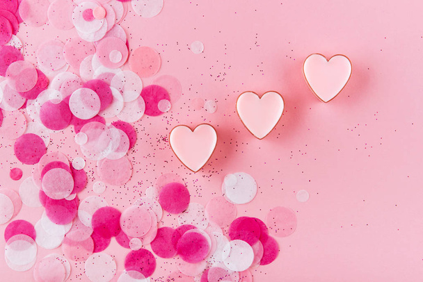 heart with confetti on pink background. Top view - 写真・画像