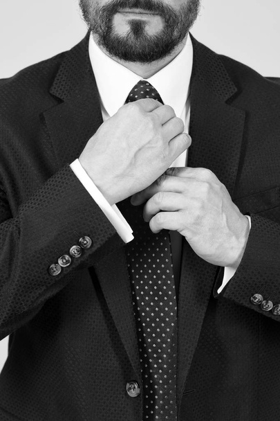 Closeup of man hands take red tie. Close up hands tie red knot. Businessman hands and blue suit. - Foto, Imagen