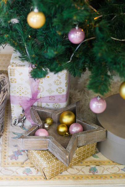 Pink and gold toys and gifts under the Christmas tree. - Foto, immagini