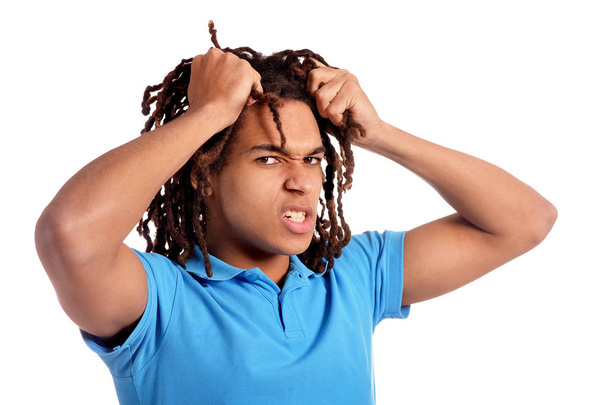 young man pulling his hair   against white background - Foto, Bild