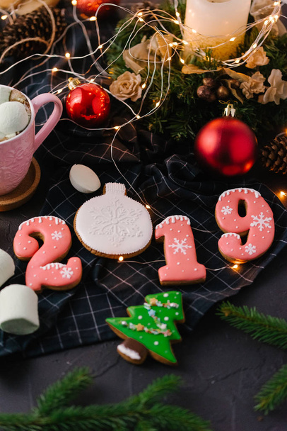 close up view of 2019 festive cookies arranged on dark surface - Photo, Image