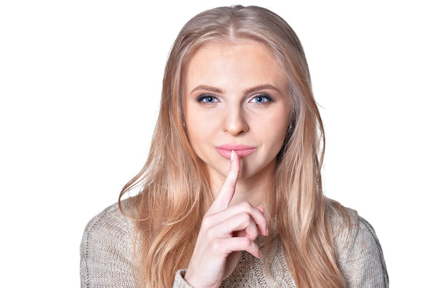 Portrait of young woman with silence gesture isolated on white background - Photo, Image