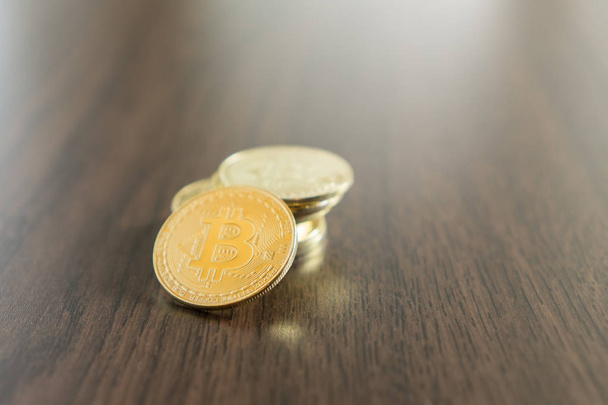 Stack of bitcoins on wooden table - Fotó, kép