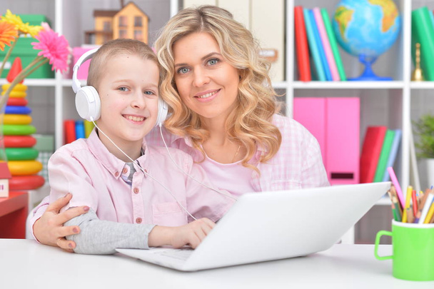 Portrait of a beautiful mother and son using laptop together - Foto, Imagen