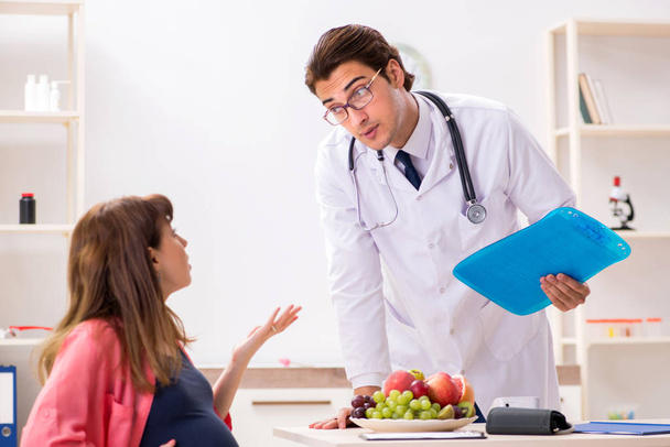 Raskaana oleva nainen vierailevat lääkäri keskustella terveellistä ruokavaliota
 - Valokuva, kuva