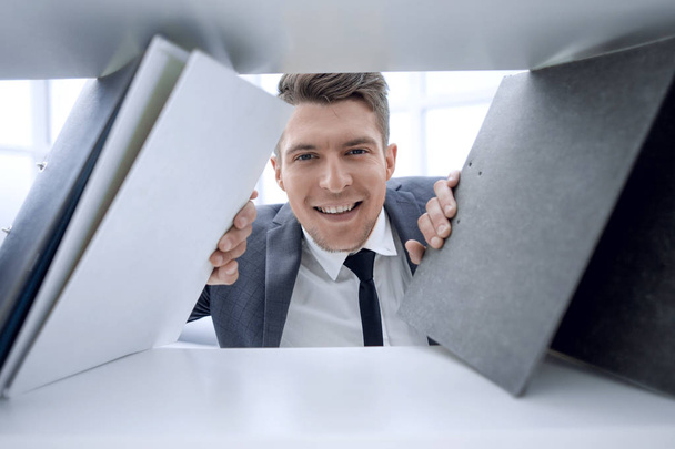 businessman in the background smiling and holding documents - Foto, Imagen