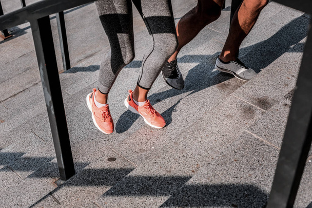 Legs of young professional runners during the workout - Foto, afbeelding