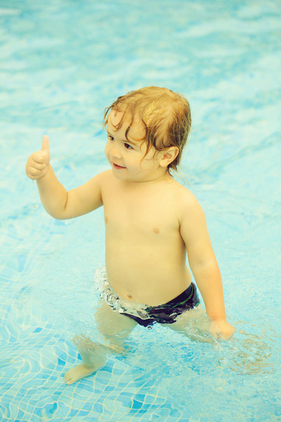 Cute cheerful baby boy gives thumbs up gesture - Fotoğraf, Görsel