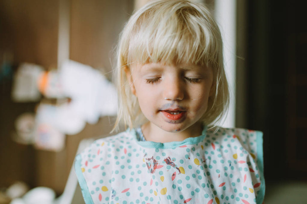 Portrait of adorable little girl with messy face covered with paint - Photo, Image