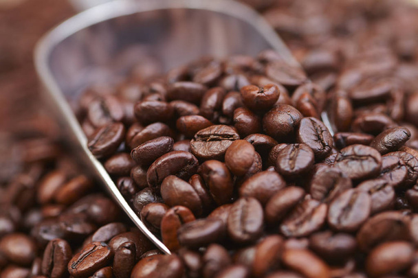 coffee beans on iron spoon, close-up  - Fotó, kép