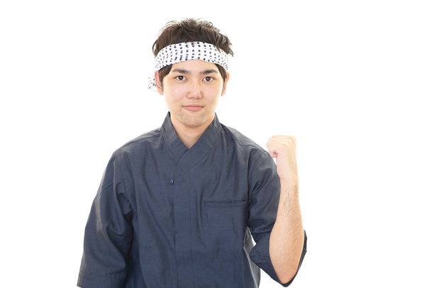 Smiling Japanese chef isolated on white background - Fotó, kép