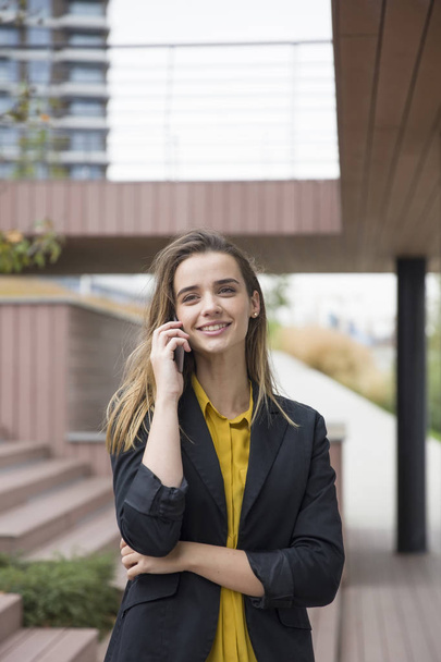 Portrait of young businesswman using mobile phone outdoor - Photo, Image
