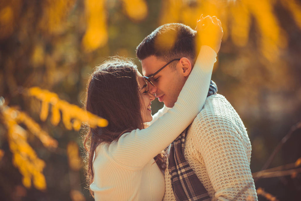 Couple in love excanges tenderness in nature, enjoying the beautiful view of autumn - Фото, изображение