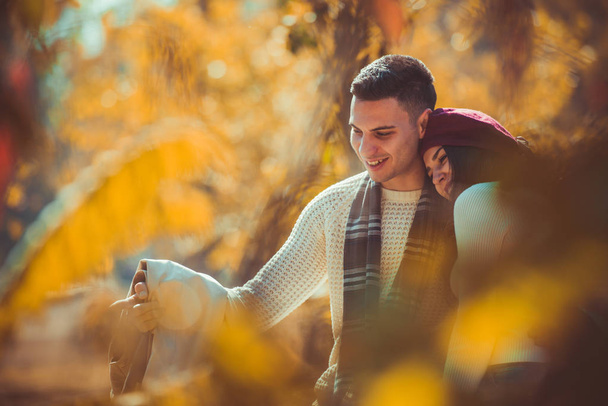 Maravillosa pareja se ve muy feliz juntos mientras pasan el día en el parque de otoño
 - Foto, Imagen