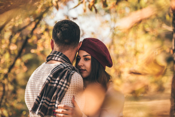 Careless couple standing next to beautiful tree and hugging each other - Photo, Image