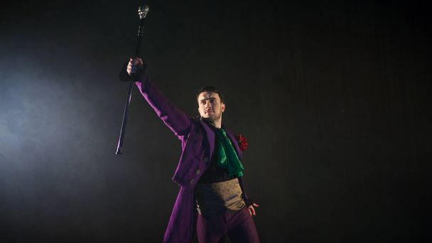 Showman points his cane up. guy in the purple camisole and the cylinder. - Фото, изображение