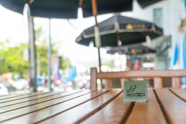 Nenhum sinal de fumar exibido em uma mesa de madeira no restaurante
 - Foto, Imagem