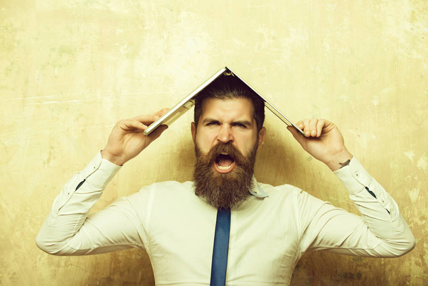 man or hipster with long beard hold laptop - Fotó, kép
